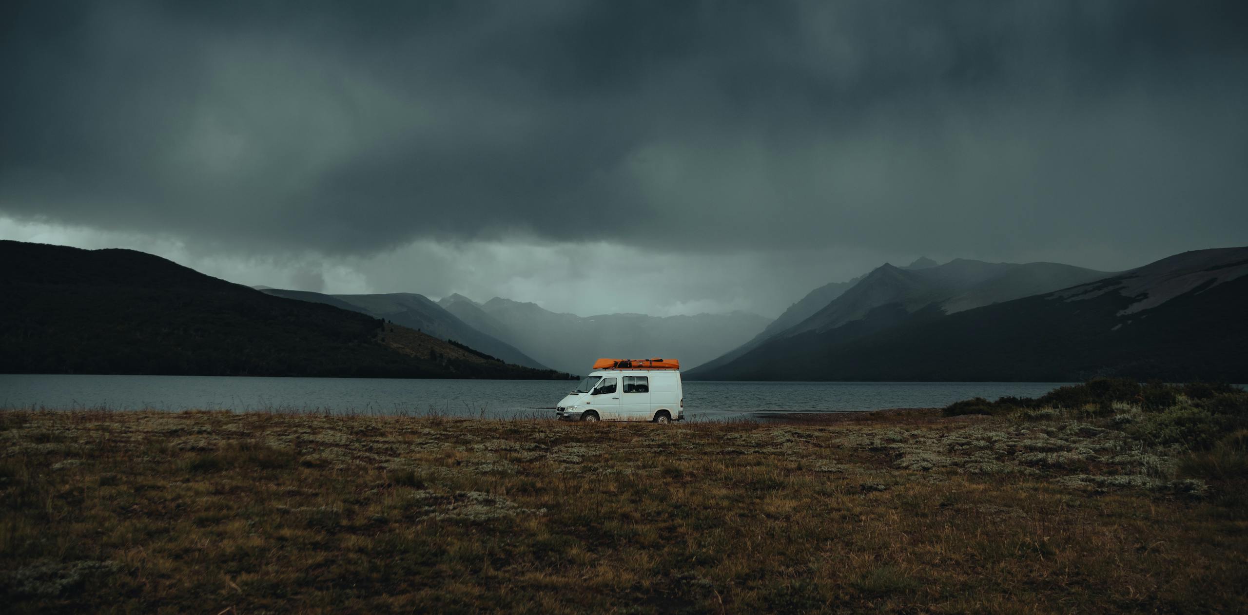 White Mini Van Parked on Overlooking Sea